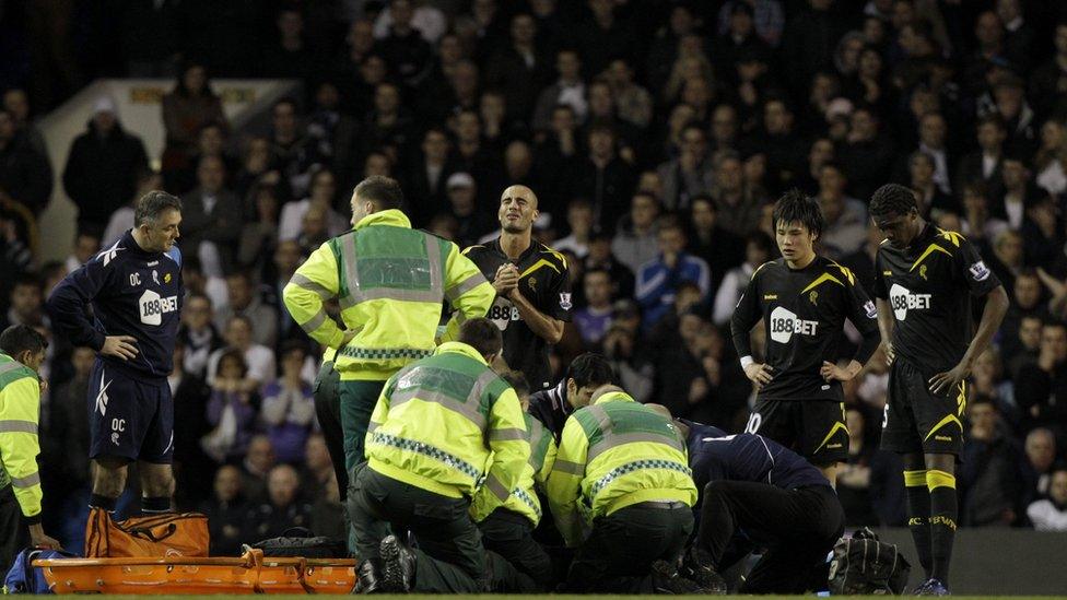 Players and paramedics treat Fabrice Muamba on the pitch after he collapsed