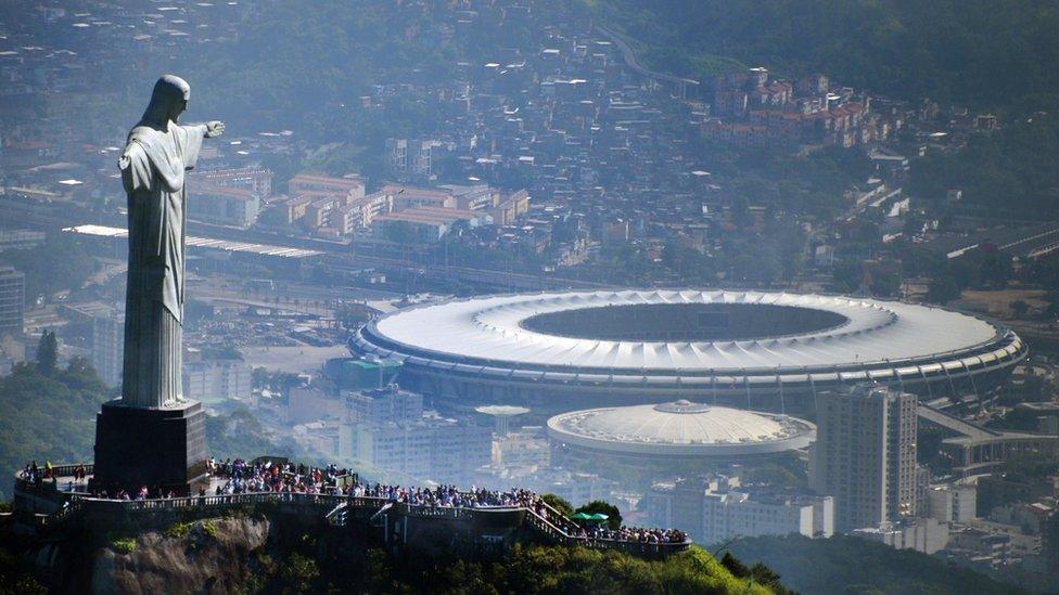 The Christ the Redeemer statue in Rio de Janeiro overlooks the Maracana Stadium