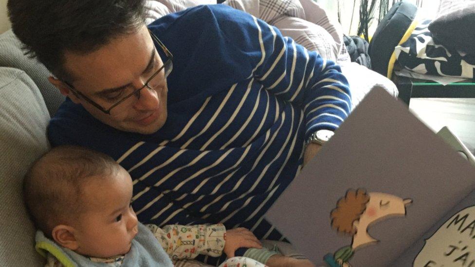 Eric Lehmann reading with son Eloi when he was six months old