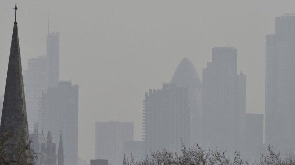 City of London financial district is seen from Primrose Hill as high air pollution obscures the skyline over London