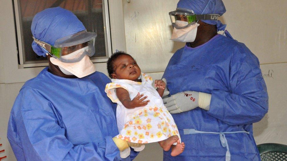 Medical workers present Noubia (C), the last known patient to contract Ebola in Guinea, during her release from a Doctors Without Borders treatment center in Conakry on November 28