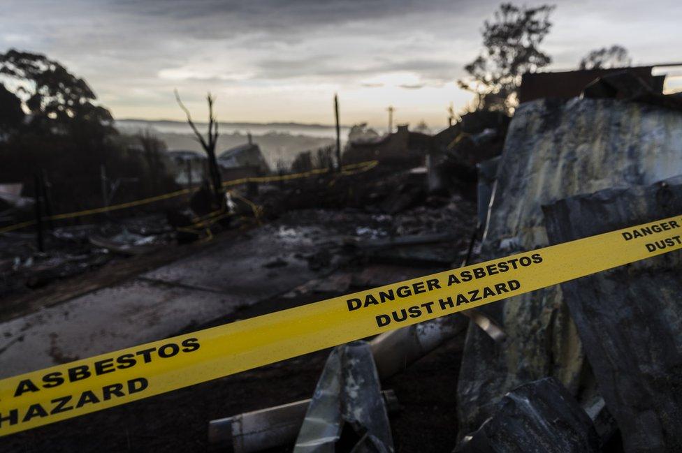 Houses destroyed by bushfire are seen at dawn on March 25, 2018 in Tathra, Australia.