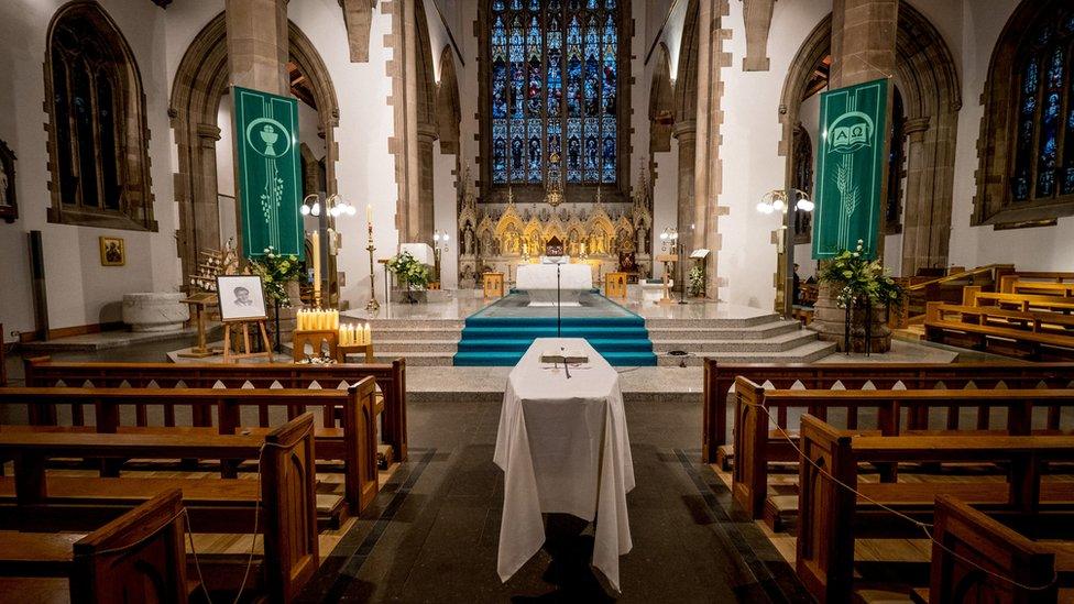 John Hume's coffin lies before the alter in St Eugene's Cathedral in Londonderry ahead of his funeral