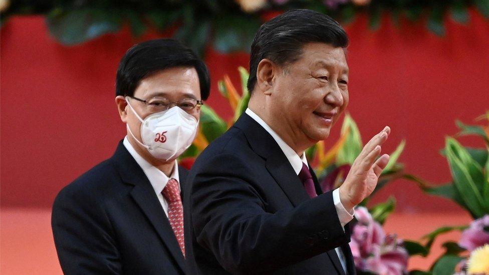 Hong Kong's new Chief Executive John Lee walks with China"s President Xi Jinping following Xi's speech after a ceremony to inaugurate the city's new leader and government in Hong Kong, China, July 1, 2022, on the 25th anniversary of the city's handover from Britain to China