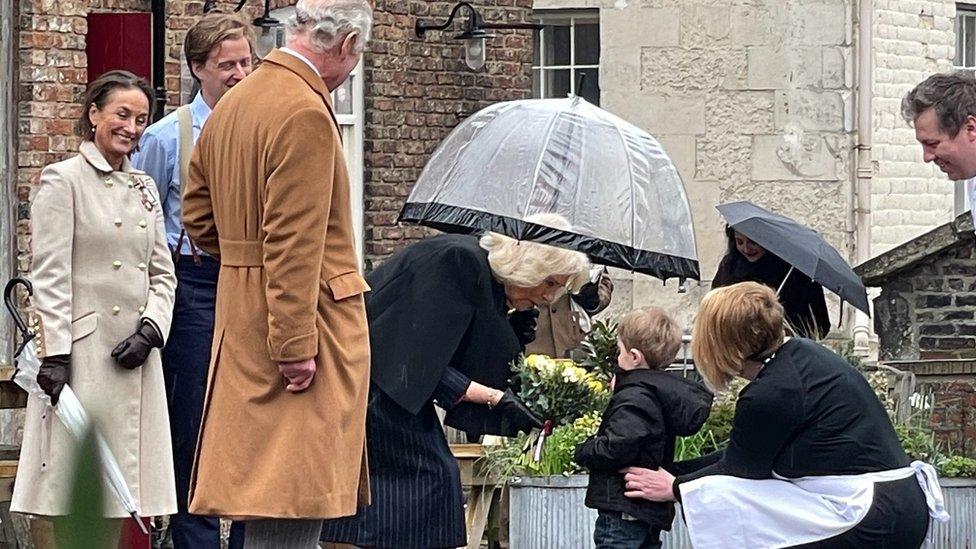 Boy presenting the Queen Consort with flowers