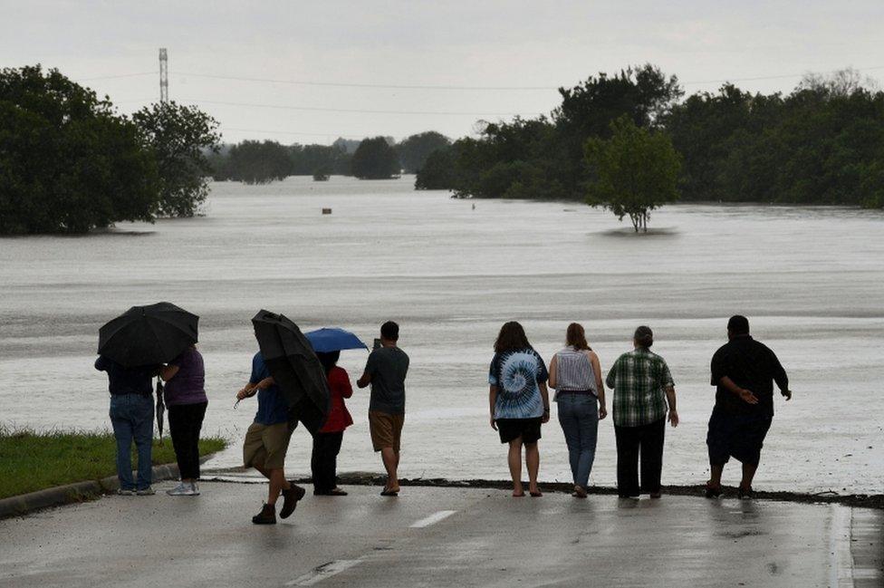 Local residents check the water level of the Barker Reservoir after the Army Corp of Engineers started to release water into the Clodine district as Hurricane Harvey caused heavy flooding in Houston, Texas on 29 August 2017.