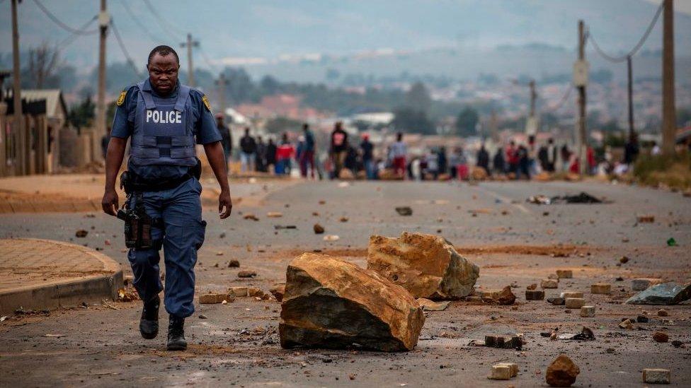 A South African police officer after a demonstration against land grabbing, housing and unemployment in Johannesburg.