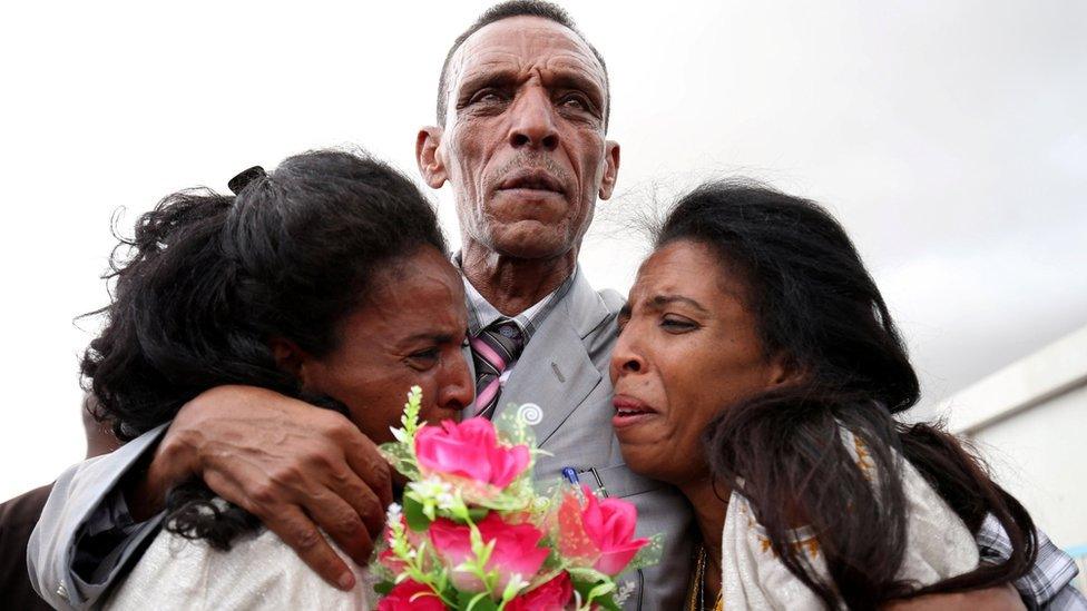 Adisalem Abu, reacts as he embraces his twin daughters, after meeting them for the first time in eighteen years, at Asmara International Airport after arriving aboard an Ethiopian Airlines flight in Asmara, Eritrea July 18, 2018.