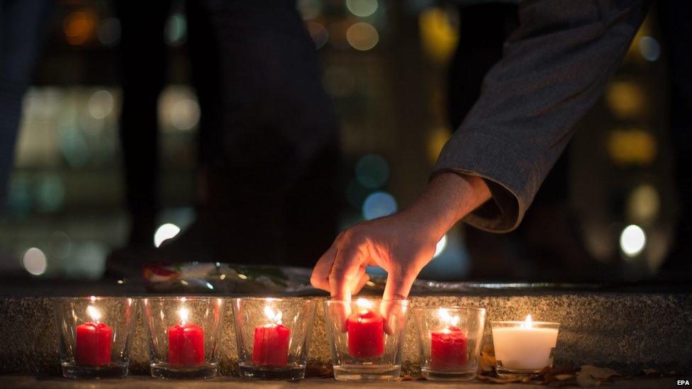 Candles outside the French embassy in Berlin, Germany.