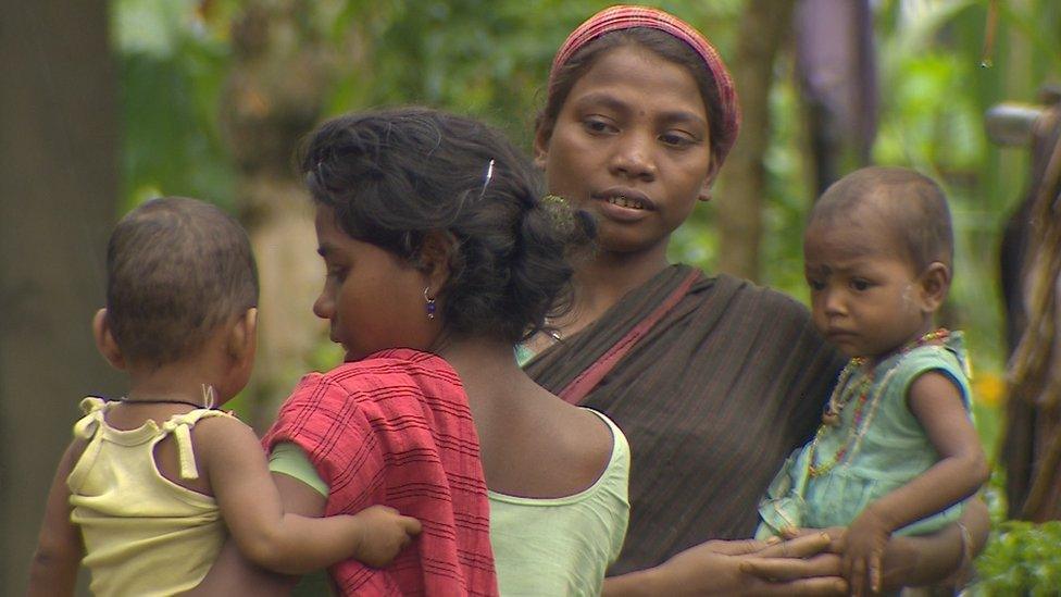 Plantation workers with their children