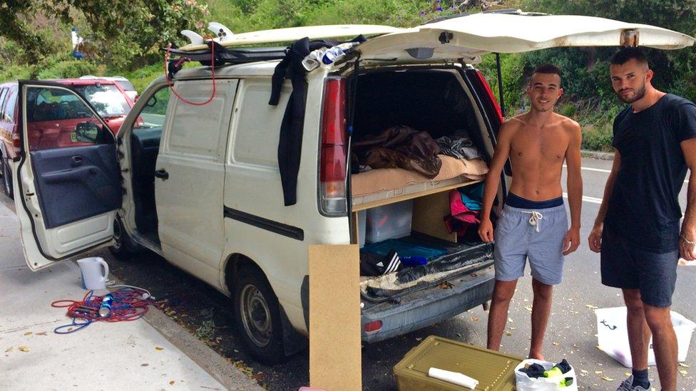 French tourists Anthony Fenech and Pierre Stoar with their van, which they sleep in