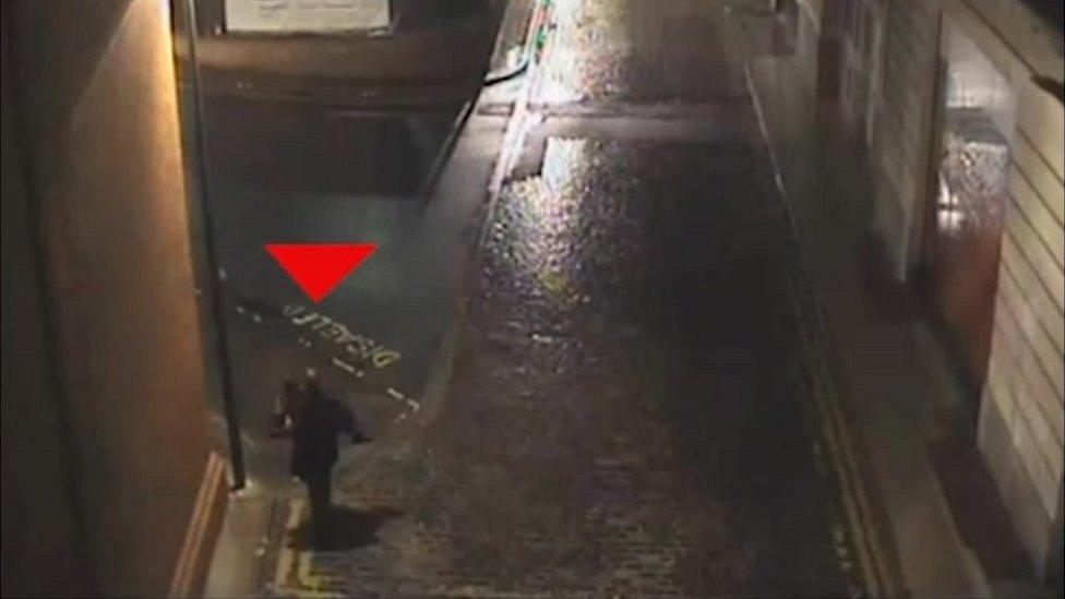 CCTV footage of a man carrying a woman in his arms