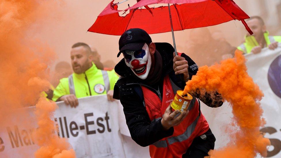 A man wearing a clown mask takes part in a demonstration in Marseille to protest against pension reforms