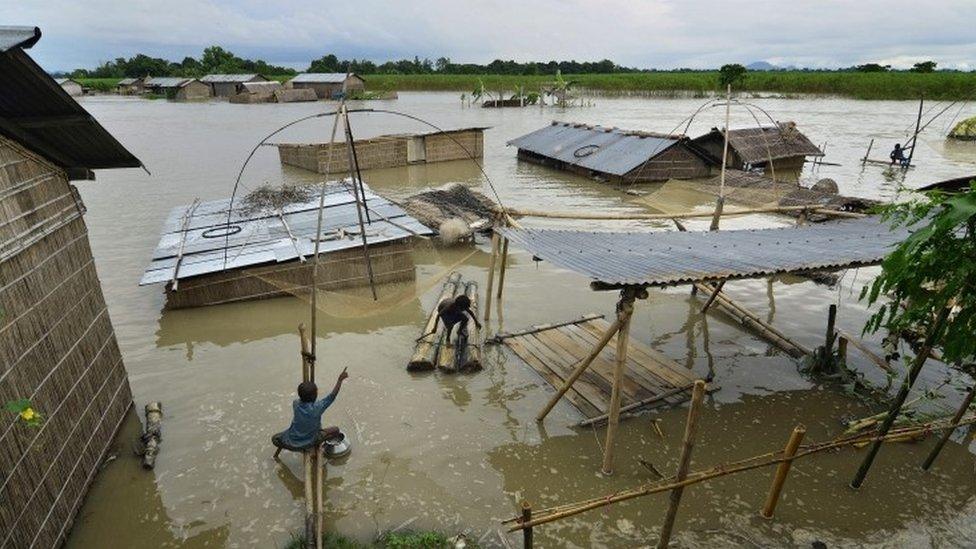 Children catching fish in their submerged village in the flood affected Morigaon district of Assam state, India, 02 September 2015.