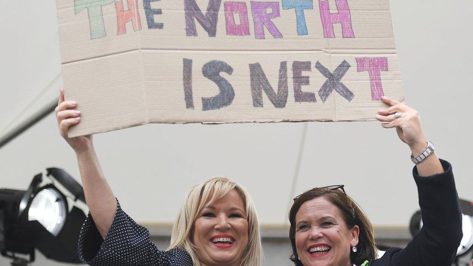 Sinn Féin's Mary Lou McDonald (right) and Michelle O'Neill hold up a placard as they celebrate the result of the abortion referendum in the Republic of Ireland