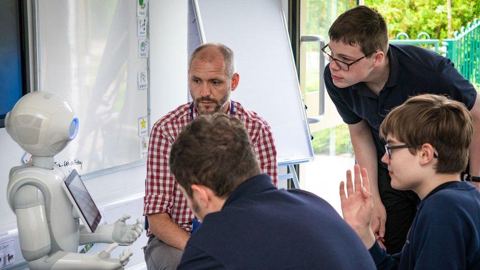 Pepper the robot with pupils and teachers