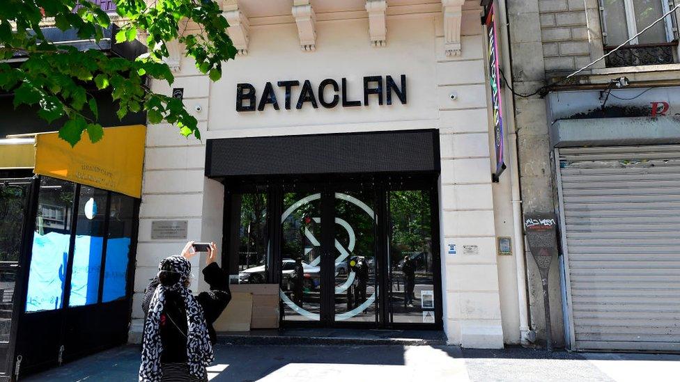 Woman taking a picture of the Bataclan music venue in Paris