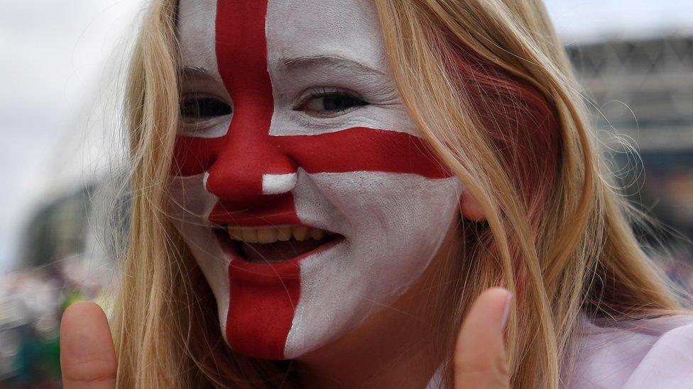 Woman with her face painted with St George's Cross flag,