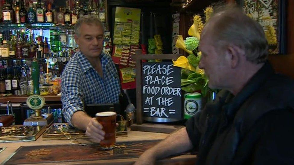 Richard Price serving a drink to a Golden Lion customer