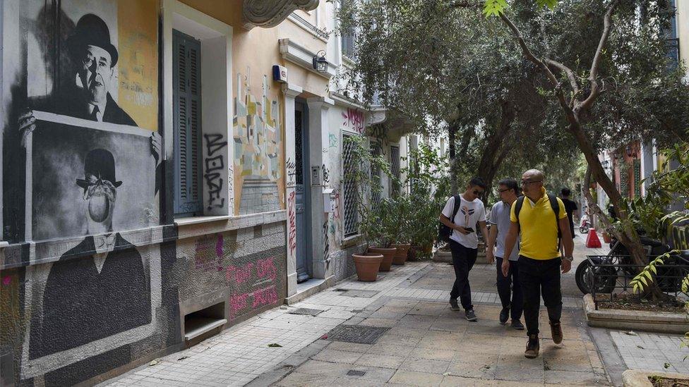 Chinese tourists visit the Athens" historic district of Exarchia on September