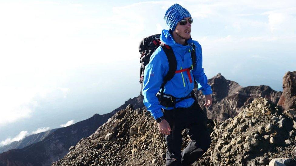 Ash Dykes climbing a mountain