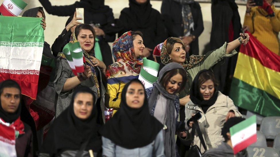 Iranian women take a selfie picture during the friendly football match between Iran and Bolivia at the Azadi Stadium in Tehran