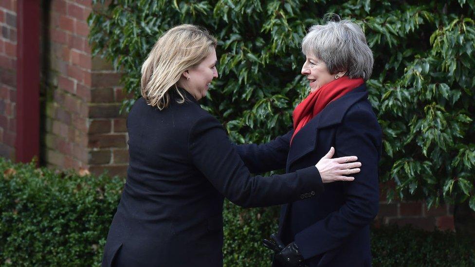 Karen Bradley greets Theresa May at Stormont in February 2018