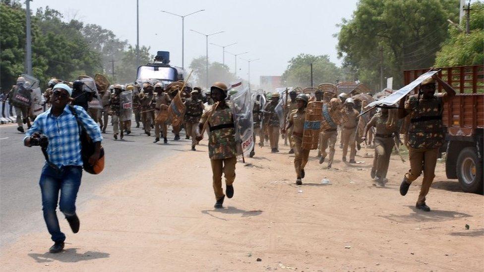 Indian police officials charge towards protestors in the southern Indian city of Tuticorin some 600 kilometres (375 miles) south of Chennai on May 22, 2018, during a protest rally held to demand the closure of a copper factory due to pollution concerns