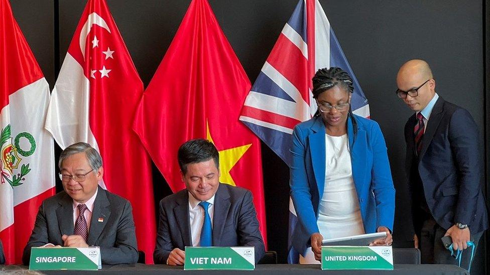 Singapore's Minister for Trade and Industry Gan Kim Yong, Vietnam's Minister of Trade and Industry Nguyen Hong Dien and British Secretary of State for Business and Trade Kemi Badenoch on the day the UK signs the treaty to join the CPTPP