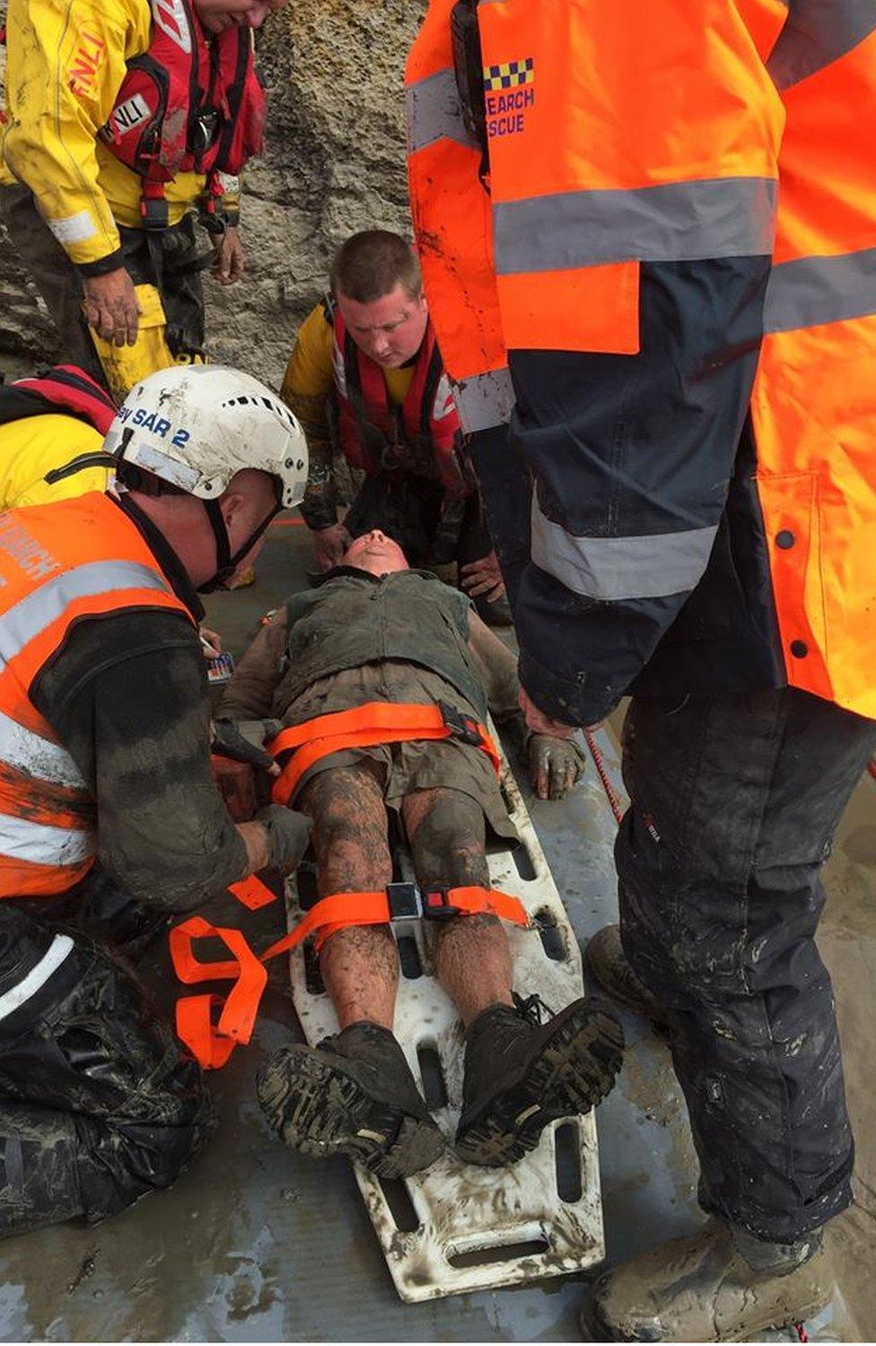 Rescuers struggle to free the man from the quicksand