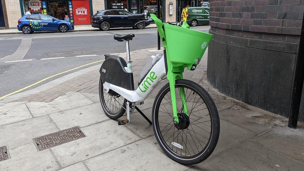 A Lime bike abandoned on a London street