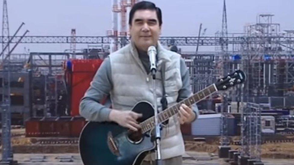 President Berdymukhamedov singing and playing the guitar