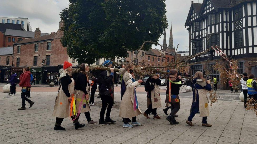 Female artists carrying the trunks through Coventry