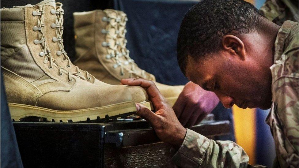 A US soldier from the 3rd Cavalry Regiment pays his respects during a memorial for Specialist Wyatt Martin and Sergeant First Class Ramon Morris at Bagram Air Field in Afghanistan, on December 23, 2014