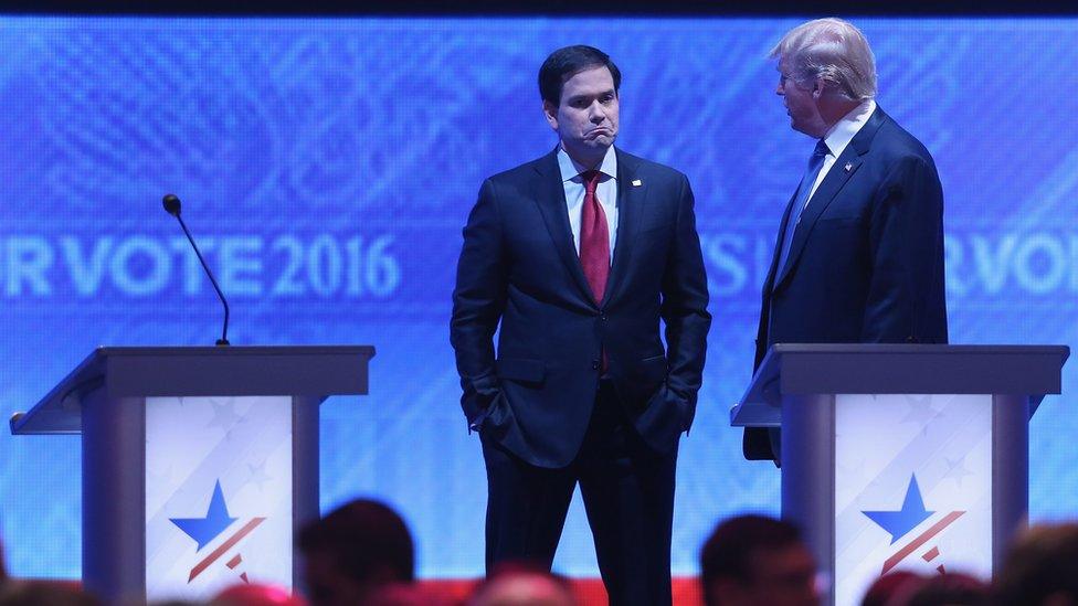Republican presidential candidates Sen. Marco Rubio (R-FL) (L) and Donald Trump talk during a commercial break in the Republican presidential debate