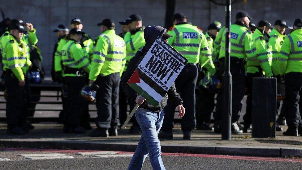 A man carrying a pro-Palestinian placard