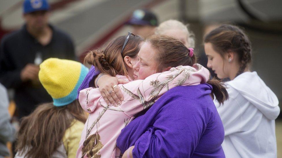 Northern California residents embrace at an evacuation centre on 15 September 2015