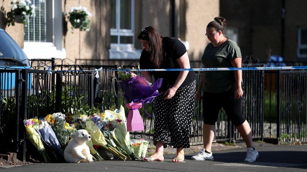 floral tributes outside the flat in Renfrew Road