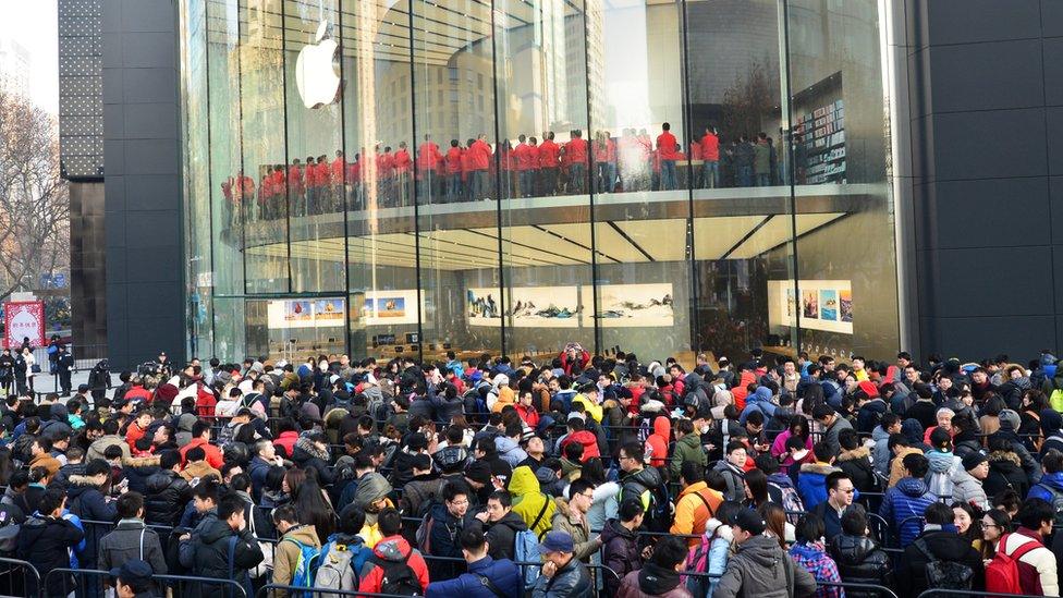 Customers line up to enter a newly opened Apple Store in Nanjing