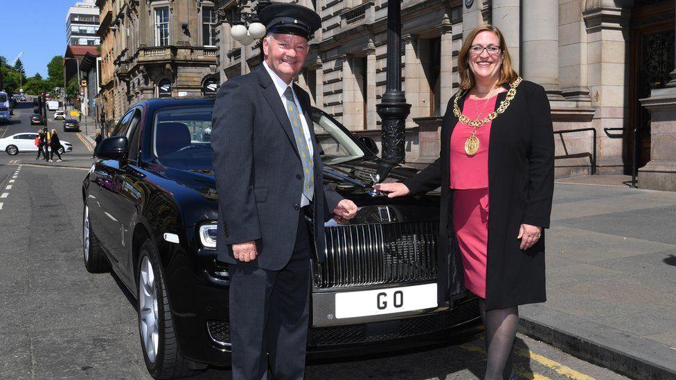 Former Lord Provost and driver standing beside Rolls Royce