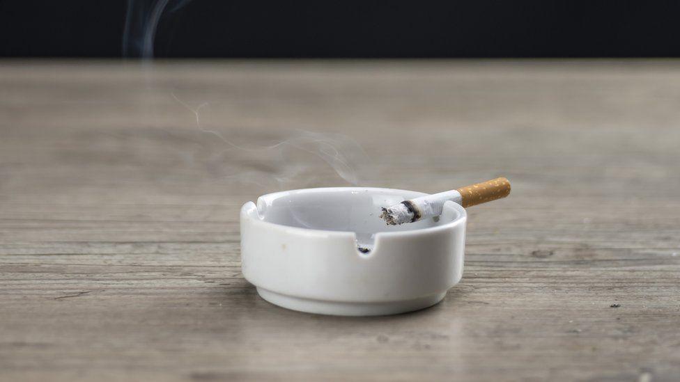 A cigarette in an ash tray