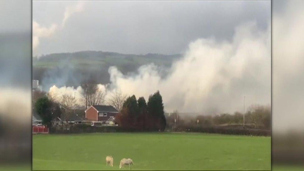 smoke blowing over house