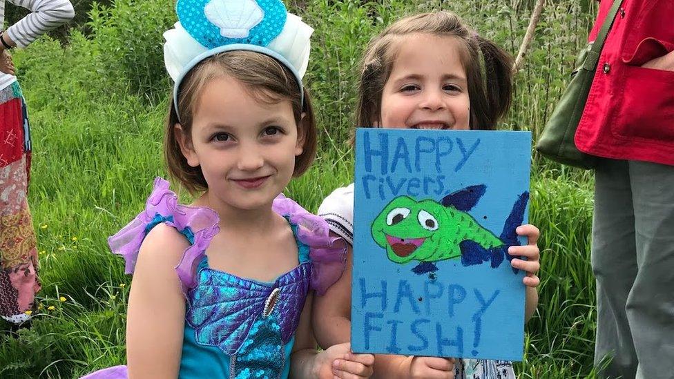 Two children holding a sign