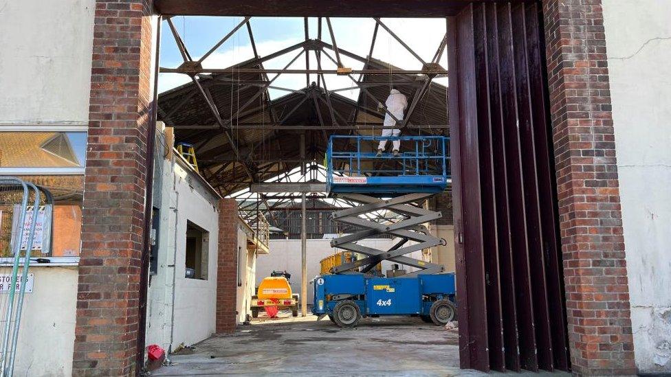 Demolition contractors at work on clearing the site