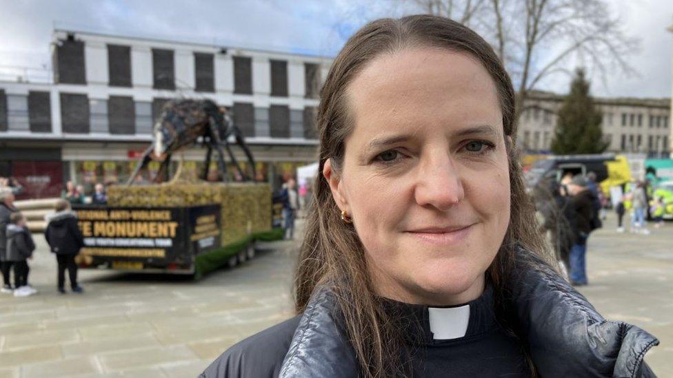 Rebecca Lloyd stood by the bee made of knives and guns in Kings Square