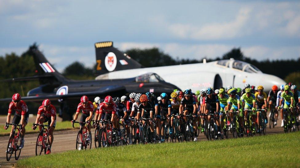 The peloton rides down the runaway at Wattisham Airfield during stage seven of the 2015 Tour of Britain