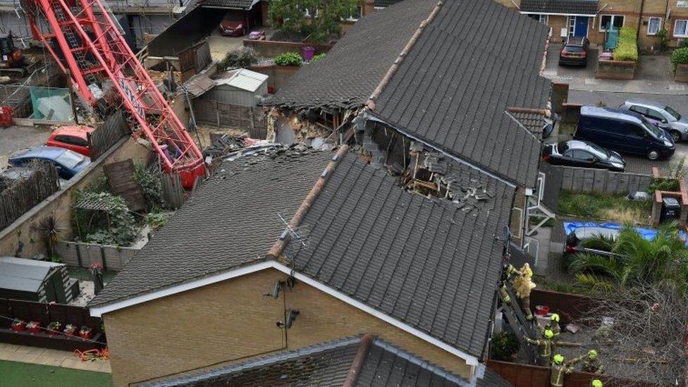 A crane crashed on to the development and two terrace houses in Compton Close, Bow