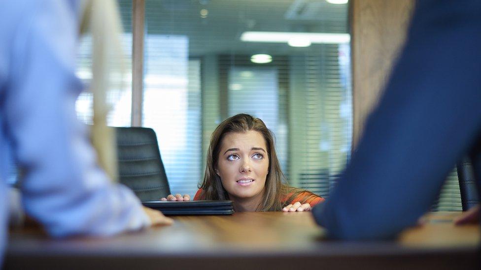 Woman coming out from under desk