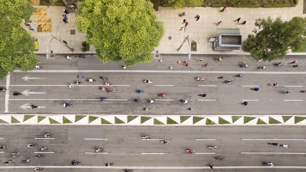 Aerial shot of people cycling at Reforma street in Mexico city.