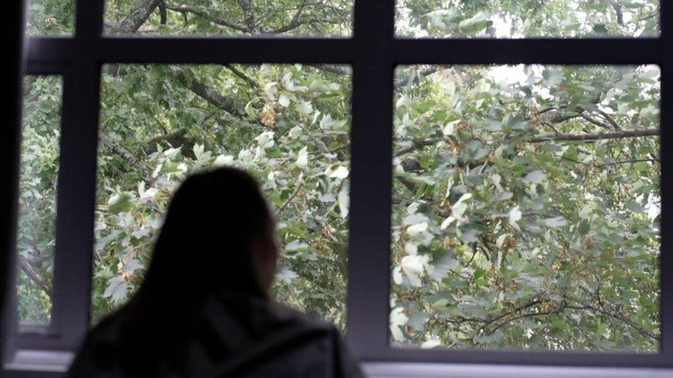 Woman looking out the window